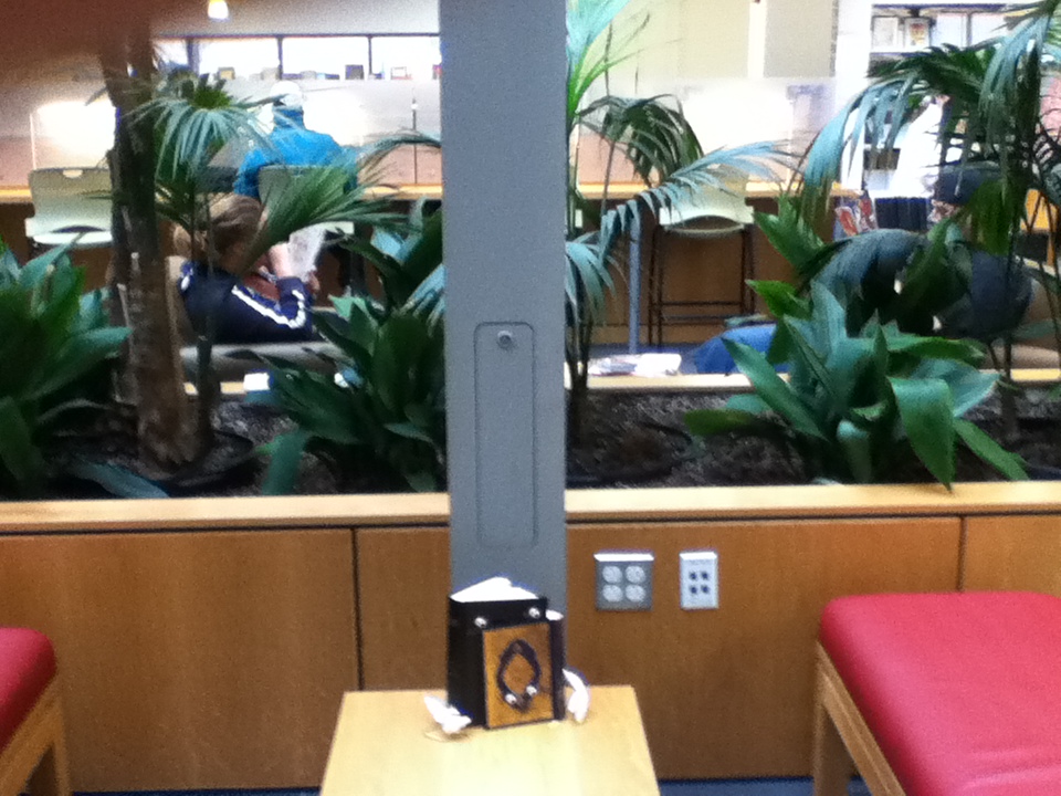 a photograph of the Bible and the Quran hugging on a table at the Portland Public Library Portland, Maine