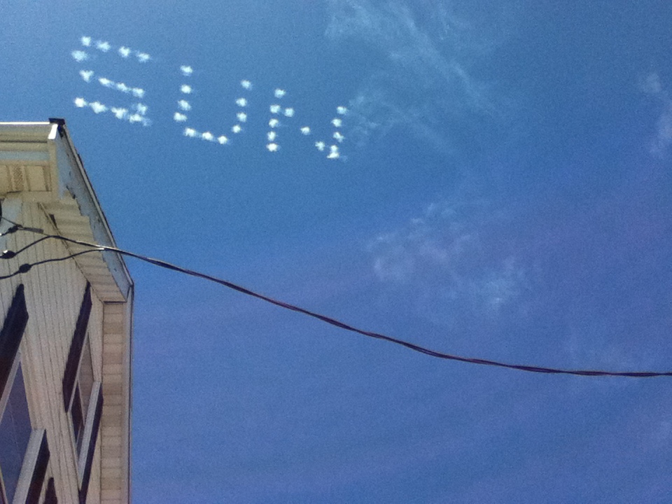 a photograph of the sky with 'sun' written on it and an electric cable underlining it